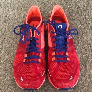 Womens red, orange, and blue On Cloud running shoes.